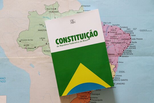 Constitui&ccedil;&atilde;o da Rep&uacute;blica Federativa do Brasil (Constitution of the Federative Republic of Brazil) placed over a map of Brazil. Concept of Brazilian law, democracy and justice.