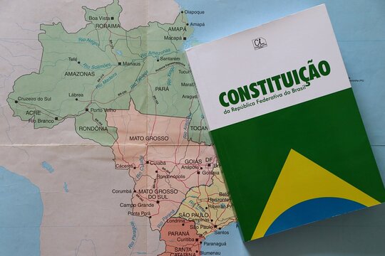 Constitui&ccedil;&atilde;o da Rep&uacute;blica Federativa do Brasil (Constitution of the Federative Republic of Brazil) placed over a map of Brazil. Concept of Brazilian law, democracy and justice.