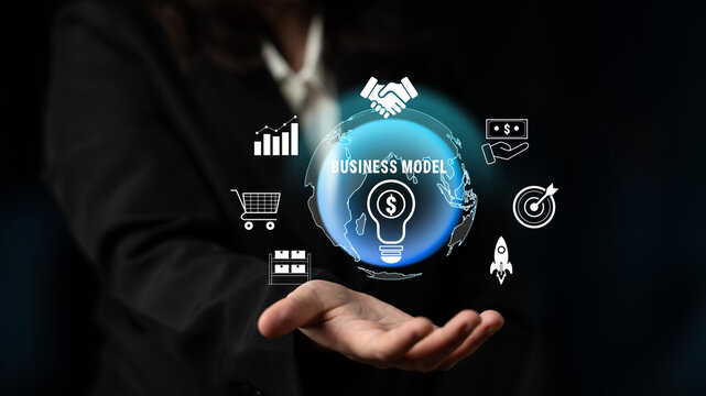 Business Model Concepts with Global and Financial Icons Represented Over an Open Hand in a Dark Background for Corporate and Startup Use Quark.