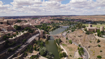 Aerial Drone View of Puente de Alc&aacute;ntara Roman Arch Bridge Spanning Tagus River, Toledo, Spain