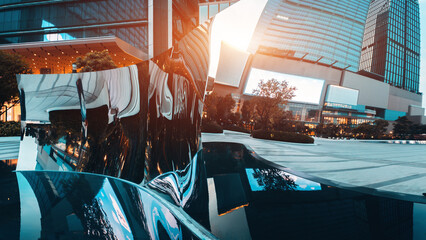Modern urban architecture of Bangkok reflected in distorted mirror sculpture with skyscrapers and city lights, Contemporary cityscape with reflective art object and glass towers in financial district