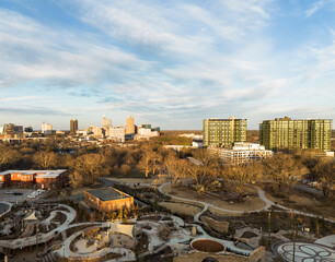 Aerial view of the Gipson Play Plaza at Dix Park with the downtown Raleigh skyline in the distance