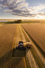 Combine harvester on the field at sunset. Aerial view © scharfsinn86