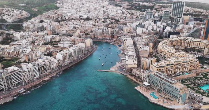 Aerial view of St. Julian's city from above, with its buildings and crystal water showing off the beautiful skyline, St. Julian, Malta.