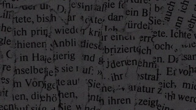 Stop motion paper crafts in vintage german text on a dark textured background great for creative design projects and presentations.