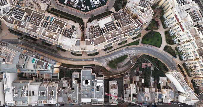 Aerial view of Portomaso Marina, where boats rest on the turquoise water, contrasting with the buildings, St. Julian, Malta.
