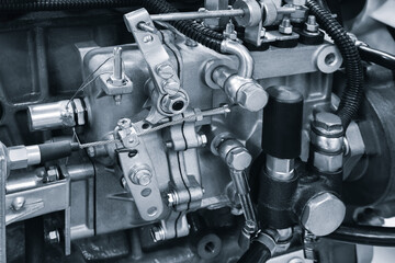 Obraz premium Close-up of diesel piston or gas engine generator fuel pump with many metal fuel and rubber lines and parts, industrial concept background, industrial concept background