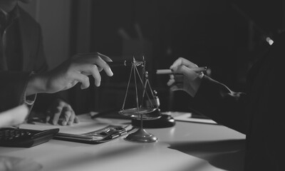 Close up of businessmen or lawyers discussing contract or business agreement at law firm office,...