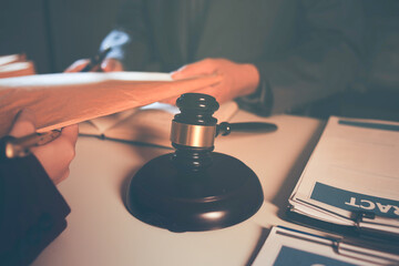 Obraz premium Close up of businessmen or lawyers discussing contract or business agreement at law firm office, Business people making deal document legal, justice advice service concept.