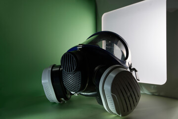 Exterminator&rsquo;s face mask with its filters, set in a colorful environment with colored lighting.