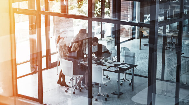 Above, planning and tablet with business people in glass office for feedback, research or review. App, coaching and flare with employee group in boardroom at work for development, meeting or update