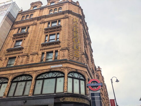 Low angle view of the iconic Harrods department store and Knightsbridge Underground station sign