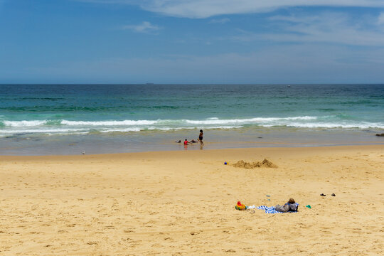 Sunny Summer Day at Bathers Way Beach in Newcastle Australia with People Relaxing on Golden Sand