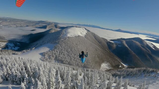 Paragliding Swinging Above Snowy Forest in Winter Alpine Mountains, Vertical Freedom Flight