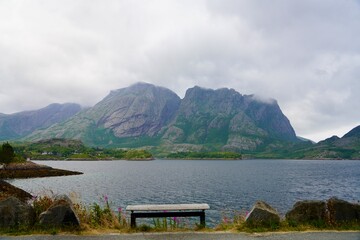 A wood bench by the roadside at Jektvik ferry quay provide a place to enjoy the dramatic Norwegian landscape.