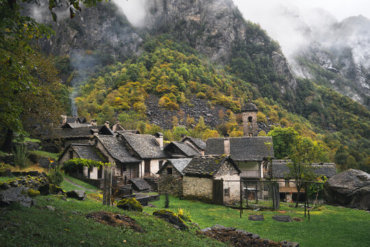 Cinematic mist drifts over Foroglio&rsquo;s stone rustici in Valle Bavona, Ticino, Switzerland, ideal for travel campaigns.