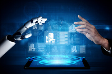 Fototapeta premium A human hand reaches out towards a robotic hand, engaged in a futuristic digital interface showcasing data visualization and real estate information on a tablet. Gantry
