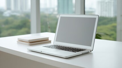 Minimalist Office Setup Featuring a Modern Laptop with a Blank Screen Positioned on a White Surface Surrounded by Green Outdoor Views
