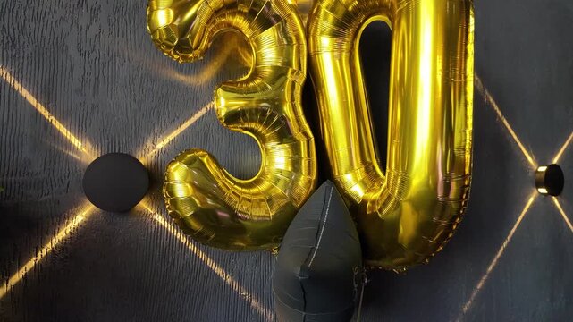 Inflatable numbers 30 against a dark wall