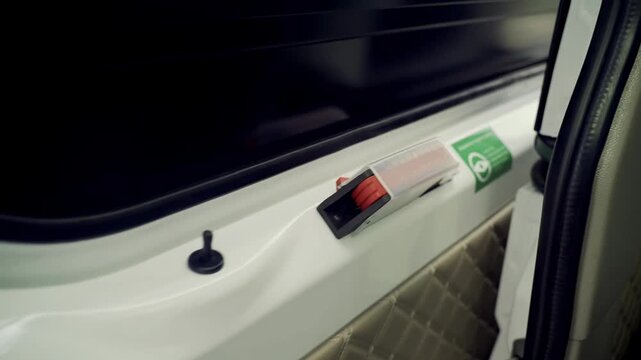 Close-up look at emergency door release in minibus for safety awareness