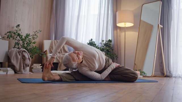 Senior woman reaches extended foot in seated side stretch