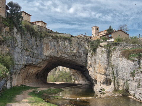 Puentedey Village on Natural Rock Arch - Iconic stone village built atop the massive natural rock bridge carved by the Nela River in Burgos, Spain.