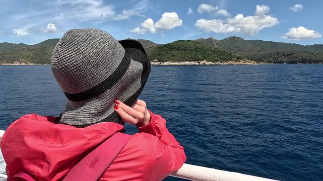 A tourist stands on the deck and sails to Elbe.