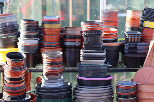 Stacks of empty plant pots in a greenhouse