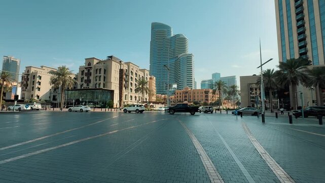 Driving montage contrasting Dubai&rsquo;s futuristic downtown skyline, with modern skyscrapers and traffic, against the charming traditional architecture 