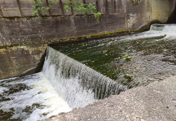 A peaceful reservoir reflects surrounding greenery.