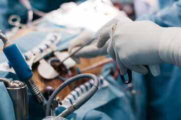 Heart valve implantation during open heart surgery. Surgeons performing precise aortic valve...