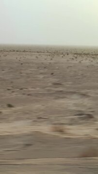 Sahara desert rally drive pov with landscape during sunrise with motion blur effect, vertical video