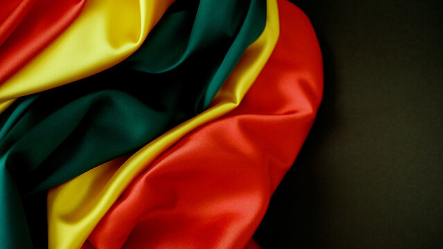 Pan African Color Silk Waves on Dark Background Celebrating Heritage and Freedom