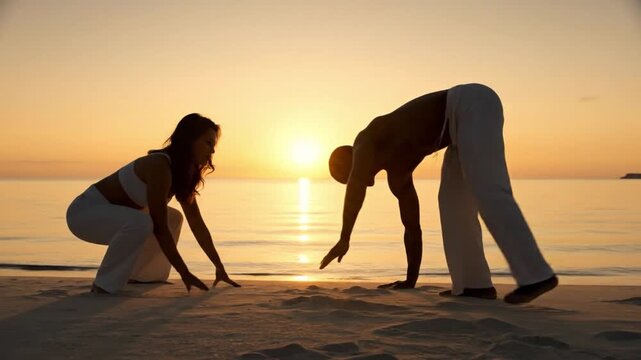 Capoeira practitioners performing on a tropical beach at sunset.