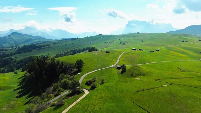 Alpe di Suisi Dolomites alps, Aerial drone view of Alpine meadow at idyllic Seiser Alm valley with mountains in background, South Tyrol. Italy