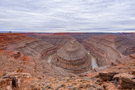 A wide-angle, panoramic view of the deep, winding entrenched meanders of the San Juan River carved into the desert landscape at Goosenecks State Park,