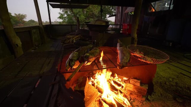 Fresh fish grilling over open wood fire