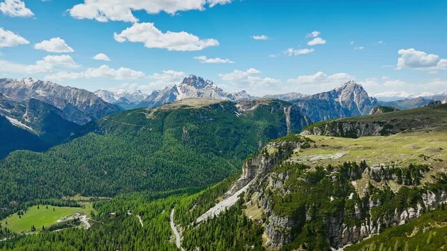 Sexten Dolomites with alpine forests and scree, aerial view. High-altitude terrain in daylight