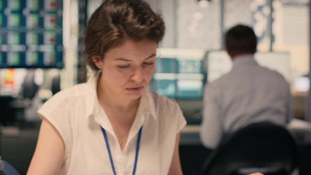 Female worker documenting essential ideas and writing on notebook, scheduling tasks and doing research for KPI. Drafting handwritten notes for business intel that reflects objectives.