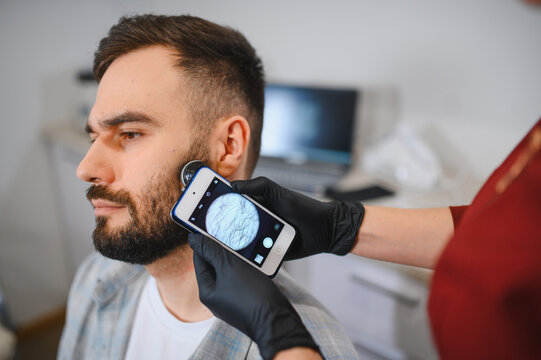 Patient receiving hair and scalp examination from trichologist