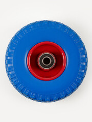 Wheel is pneumatic on a white background. Blue rubber, red disc.
