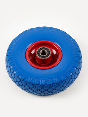 Wheel is pneumatic on a white background. Blue rubber, red disc.