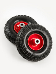 Two wheels from a garden cart on a white background. Black rubber, red disc.