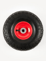 Wheel is pneumatic on a white background. Black rubber, red disc.