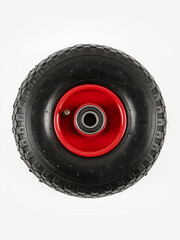 Wheel is pneumatic on a white background. Black rubber, red disc.