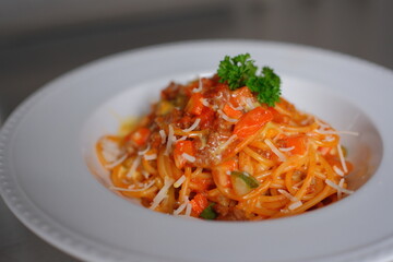 Delicious pasta with tomato sauce and cheese on white plate