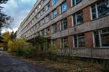 Obraz premium Abandoned white brick multistory houses, decaying cityscape of ghost town