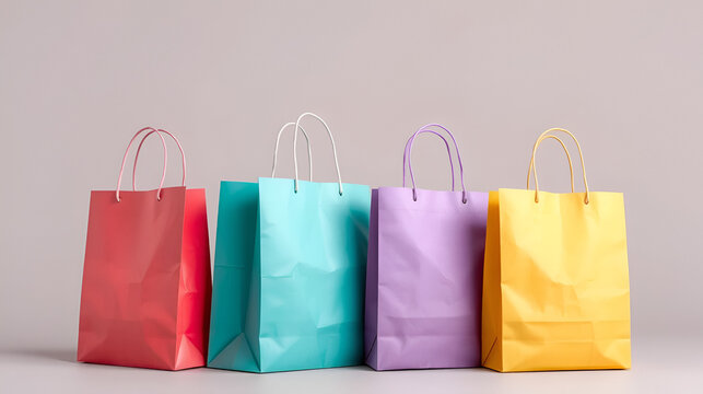 Isolated multicolored paper shopping bags for carrying products, sale or gifts on a surface
