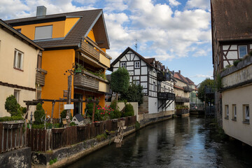 Obraz premium Traditional Fachwerkhäuser timber framed houses along the Wiesent River in Forchheim old town, Bavaria, Germany, historic Franconian architecture and picturesque medieval European riverside town.