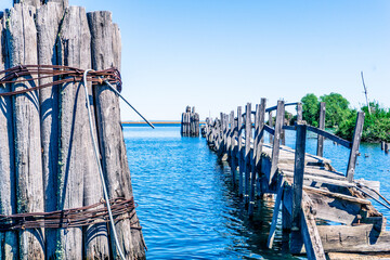 A wooden pier with a bridge over a body of water